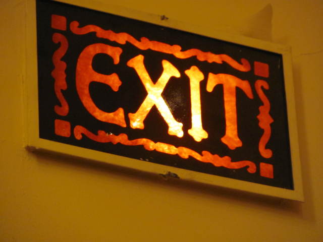 RHODE, Kenosha, Wisconsin. This original GATEWAY-era exit lamp is on the wall between the grand lobby and the outer vestibule. 