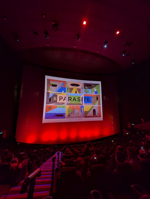 Screen showing slideshow featuring Parasite poster