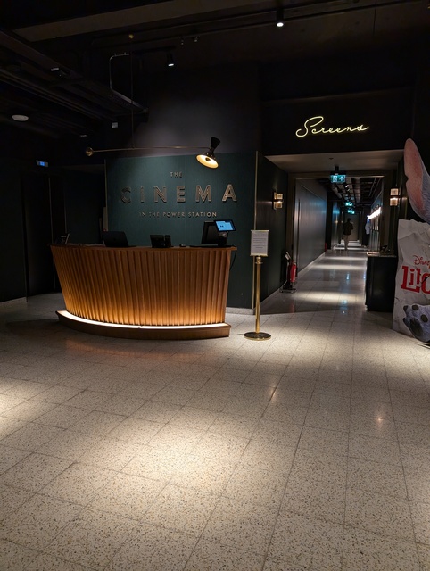 Foyer desk with corridor leading to screens