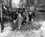 March 29, 1964 photo & description credit John Vogele/Chicago Tribune. "Mrs. Helen Marshall holds the hand of her daughter Gale, 3, as they cross a slushy Randolph Street at State Street."