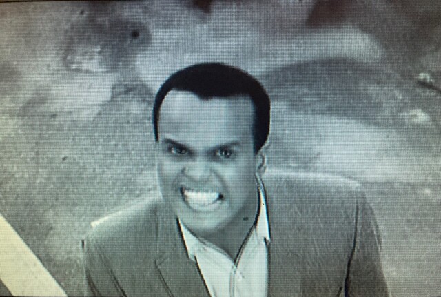 Screenshot from the documentary, "Sing Your Song" (2011)